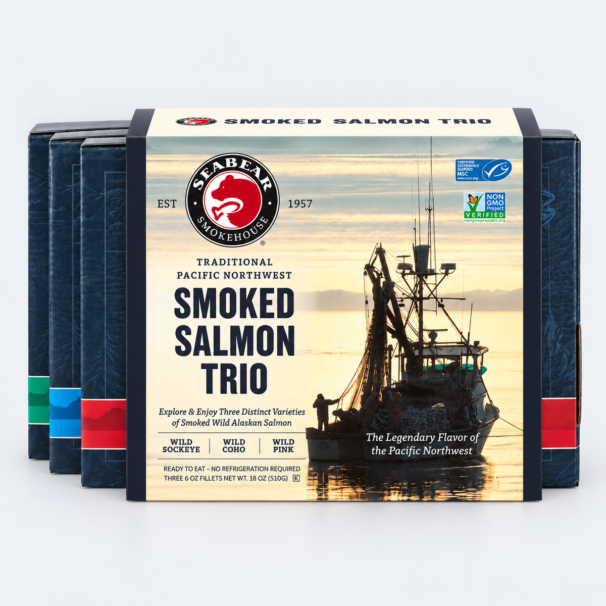 SeaBear Smoked Salmon Trio featuring Wild Sockeye, Wild Coho, and Wild Pink Salmon in a Pacific Northwest gift box with a fishing boat silhouette on the packaging.
