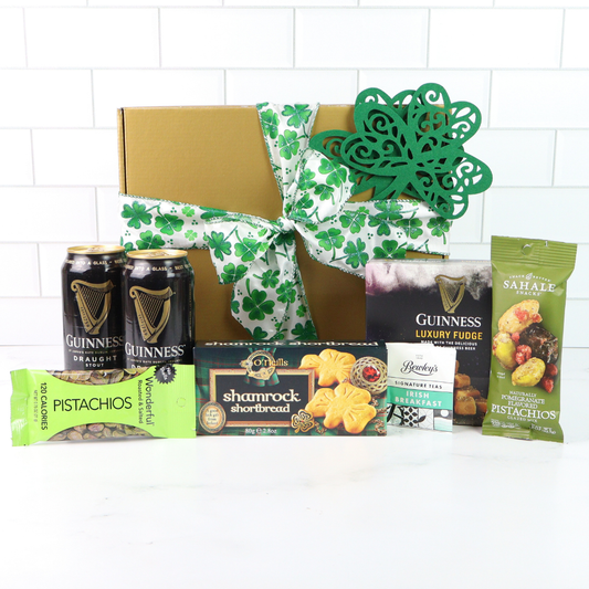 Gift basket with Guinness beer, snacks, and treats on a white background
